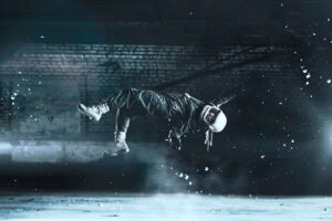 A cosmonaut floats effortlessly in an artistic fashion amidst a dimly lit indoor space.